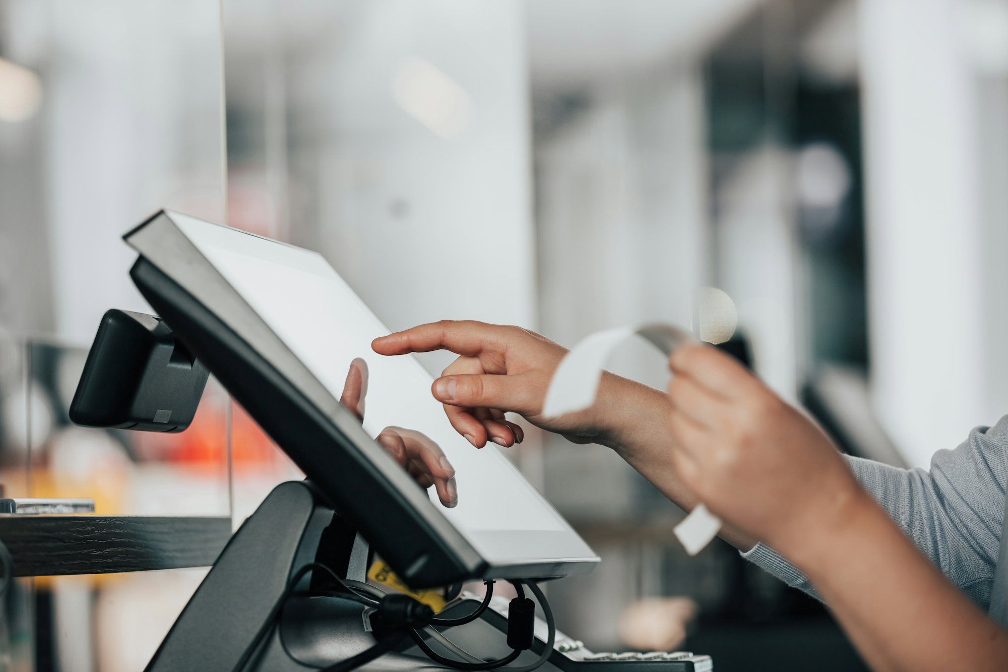 a-person-is-using-a-pos-machine-in-a-store.jpg a person is using a pos machine in a store